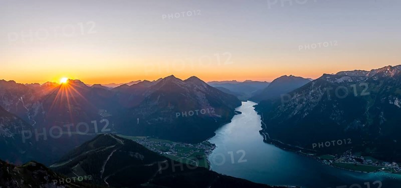 Last rays of sun over mountain landscape at sunset
