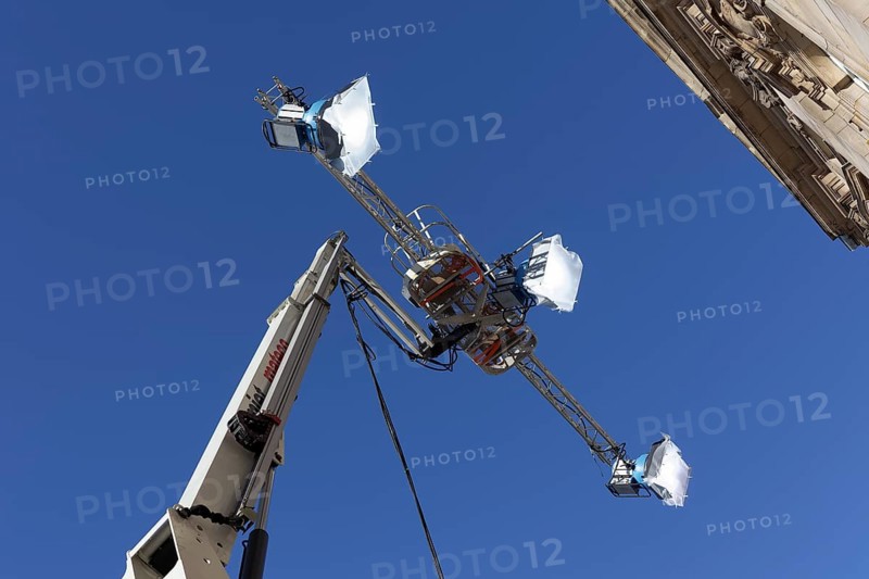 Three spotlights in front of a blue sky
