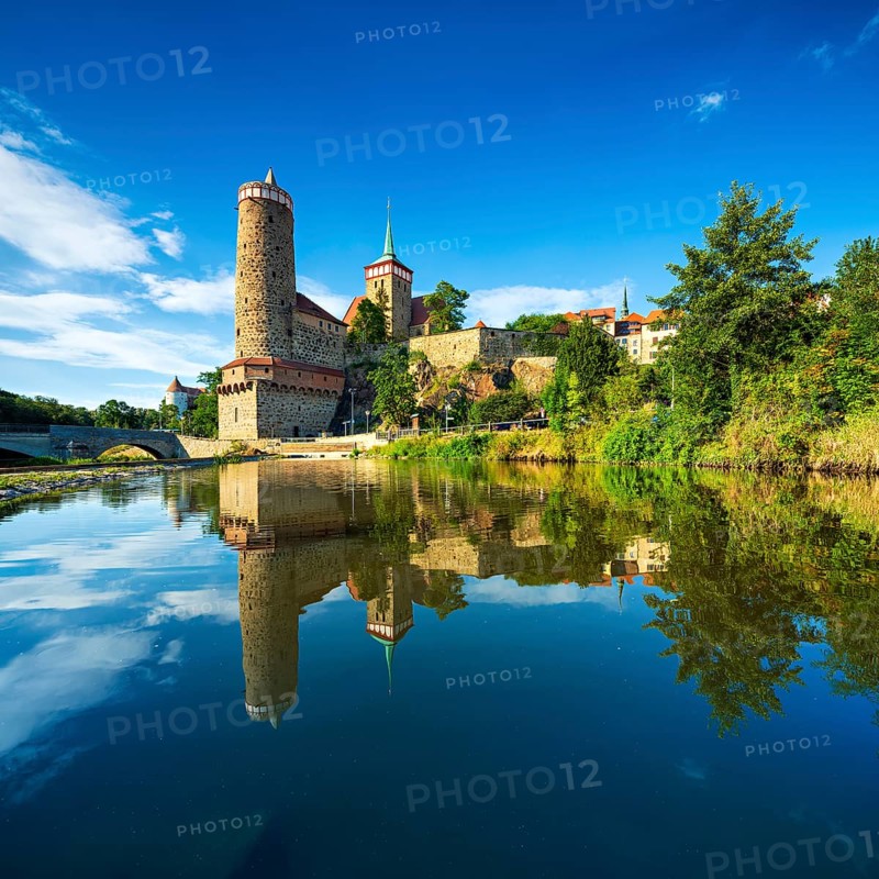 Old water art and St. Michael's church reflected in the water of the Spree