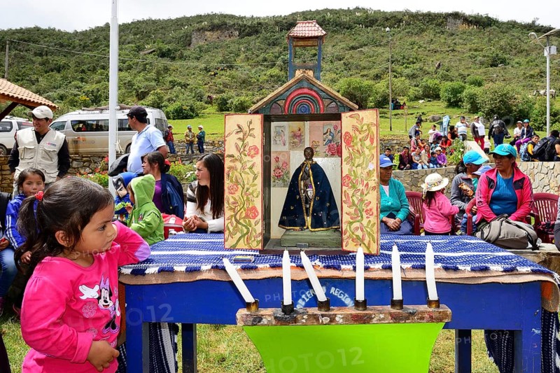 Little indigenous girl looking at a shrine during a folk festival