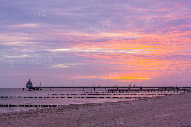 Groyne and diving gondola with pier at the beach of Zingst at sunrise