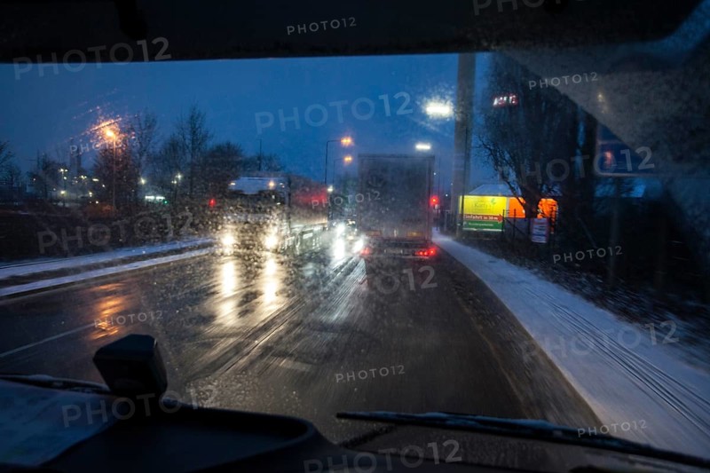 Driving a truck at dawn in winter with poor visibility and road conditions