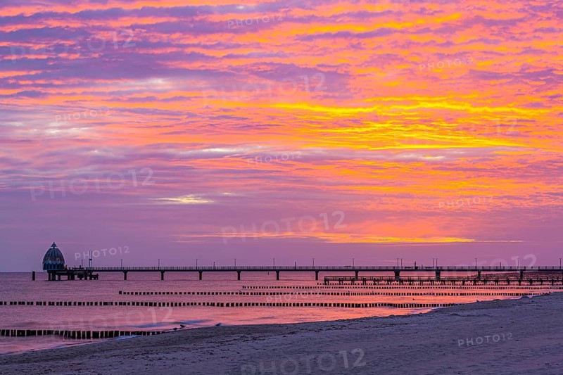 Groyne and diving gondola with pier at the beach of Zingst at sunrise