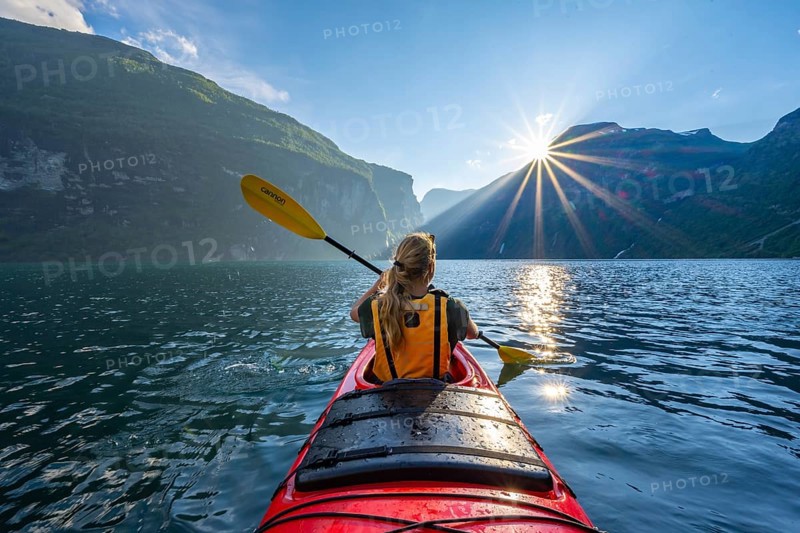 Young woman paddling in a kayak