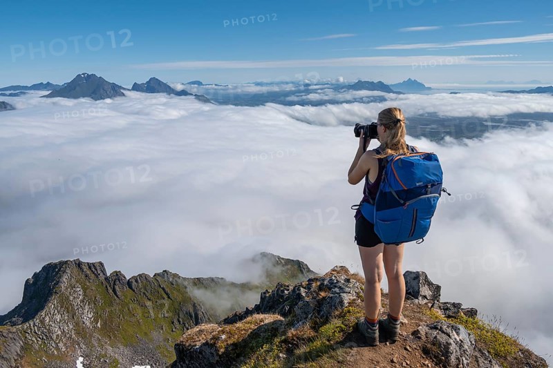 Hiker looking over mountain landscape in fog