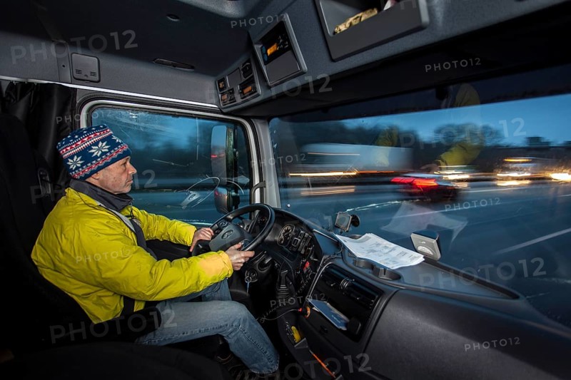 Driving a truck at dawn in winter with poor visibility and road conditions