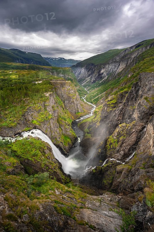 View into the river valley with waterfall Voringfossen