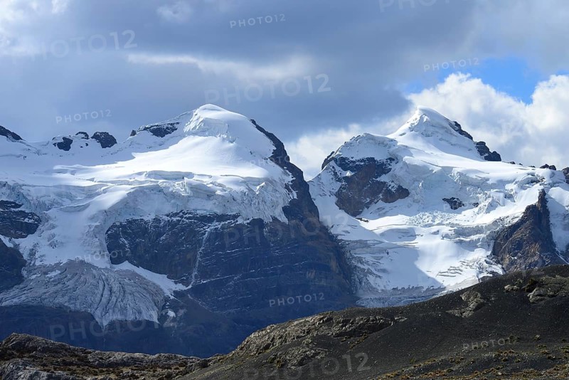 Iced mountain peaks with clouds