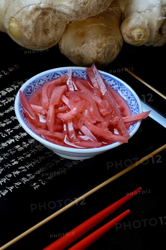 Pickled ginger in small bowls and ginger root