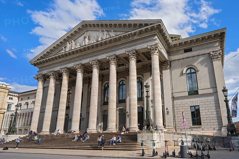 People sunbathing on the stairs in front of the opera