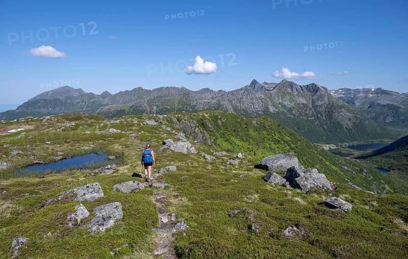 Hiker on the trail to the mountain Rundfjellet