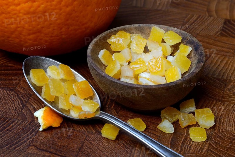 Candied orange peel cubes in small bowls and spoon