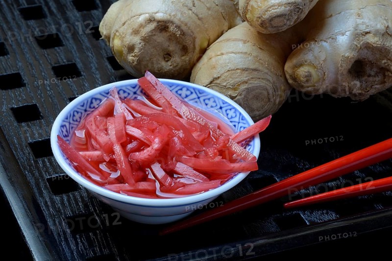 Pickled ginger in small bowls and ginger root