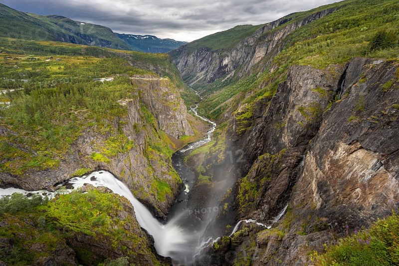 View into the river valley with waterfall Voringfossen
