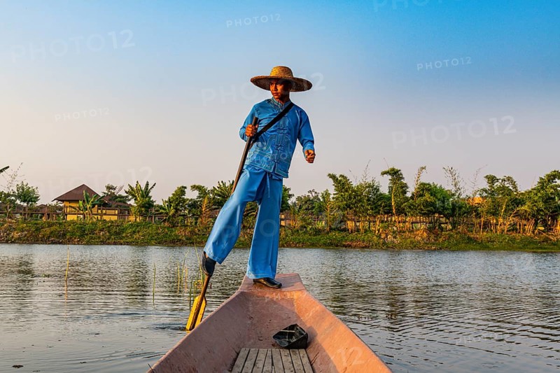 Fisherman at Inle Lake with traditional Intha conical net at sunset