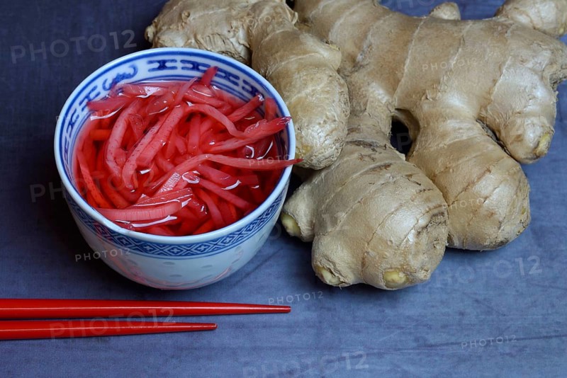 Pickled ginger in small bowls and ginger root