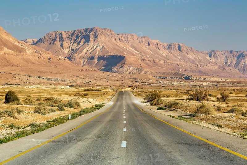 Endless road driving empty desert landscape boundless lonely infinite distance in Israel