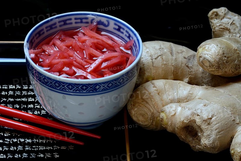 Pickled ginger in small bowls and ginger root