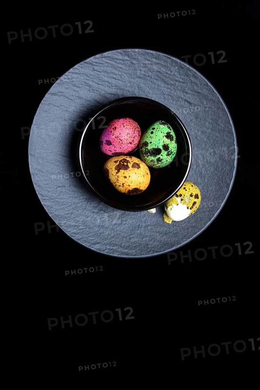 Coloured quail eggs in small bowls