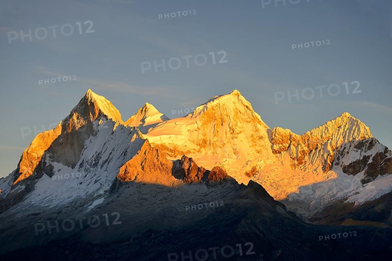 Shining mountain range Nevado Huandoy at sunrise