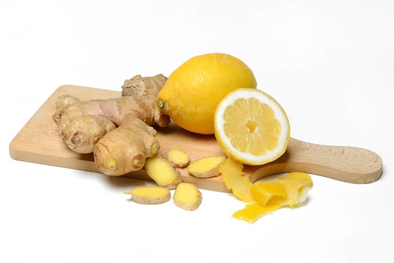 Ginger root and lemon on wooden board