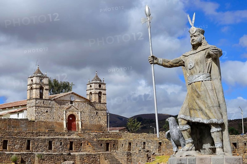 Statue of the Inca Pachacutec in front of sun temple with attached cathedral from the colonial period