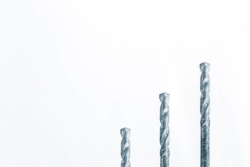Three drills in front of white surface