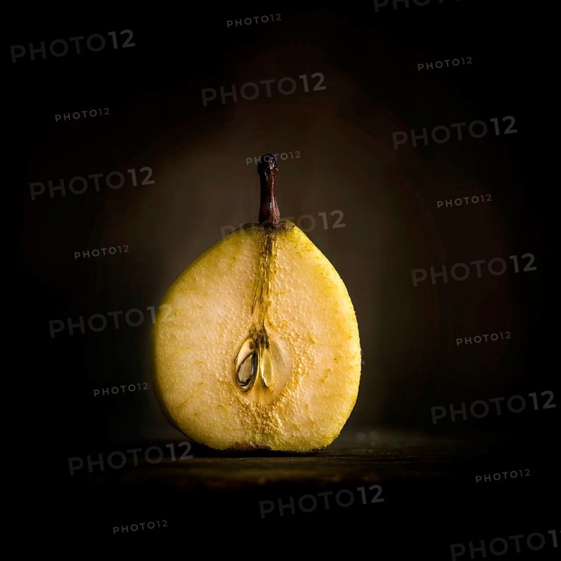 Halved pear on dark background