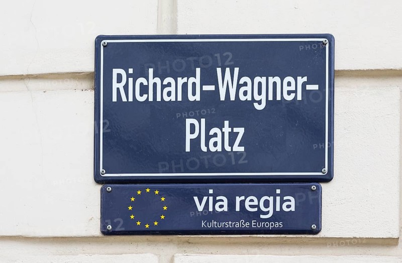 Street sign Richard-Wagner-Platz and sign for the Via Regia European Cultural Route on a house wall