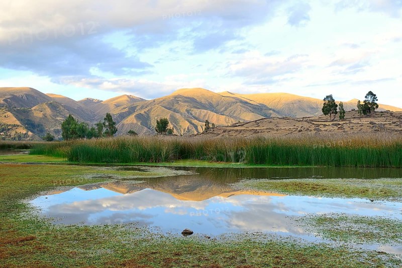 Reflection of bare hills in the Laguna Pumaqucha at the Inca ruins of Inti Watana
