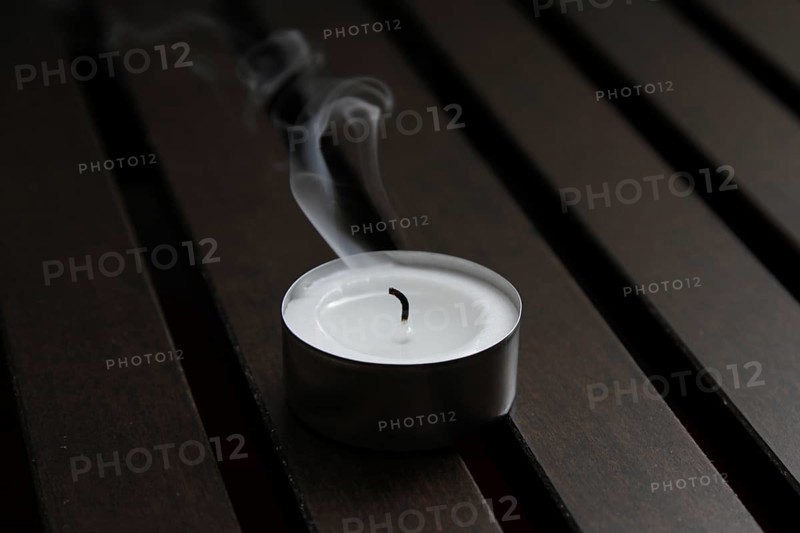 Tea light on wooden background