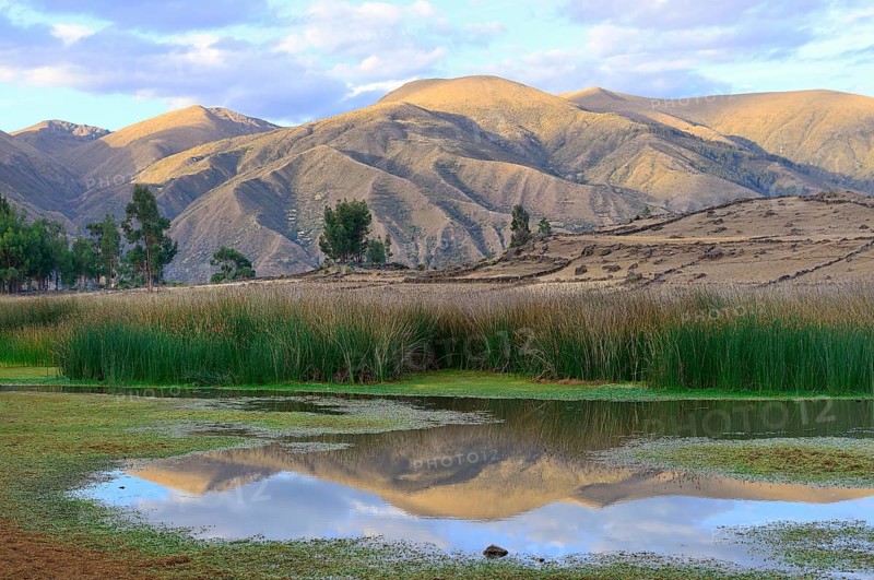 Reflection of bare hills in the Laguna Pumaqucha at the Inca ruins of Inti Watana