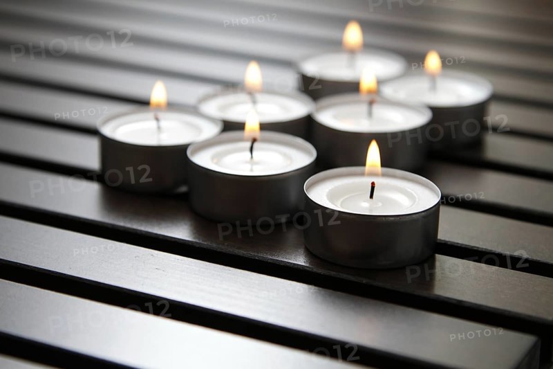 Tea lights on wooden background