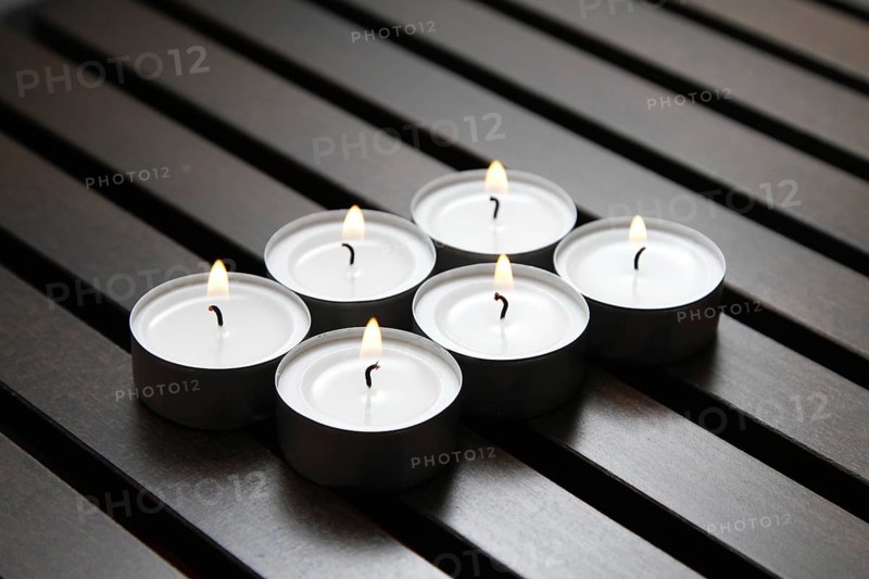 Tea lights on wooden background