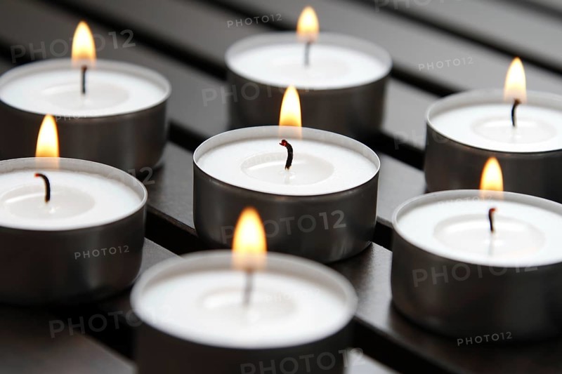 Tea lights on wooden background