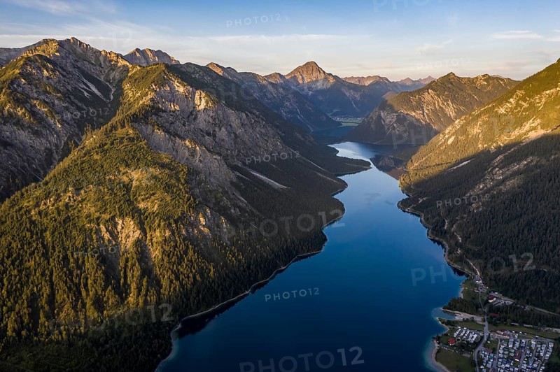View from the summit of Schoenjoechl to Plansee and mountains at morning sun