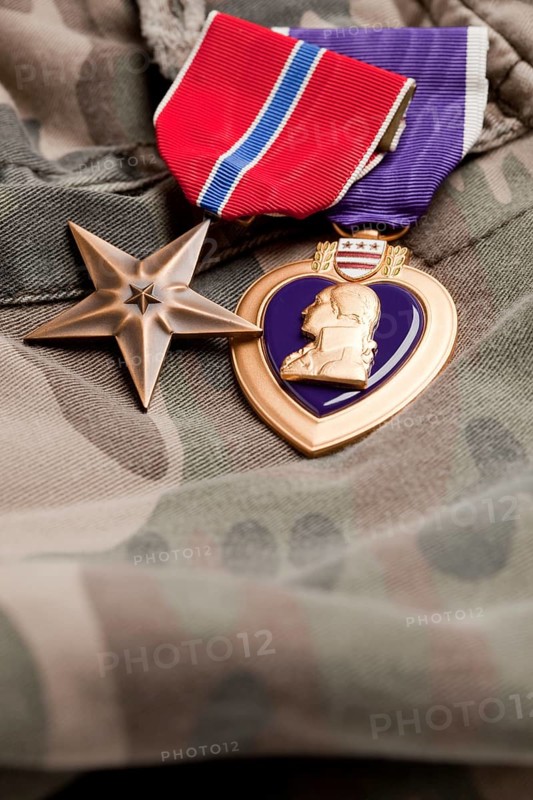 Bronze and purple heart medals on camouflage material