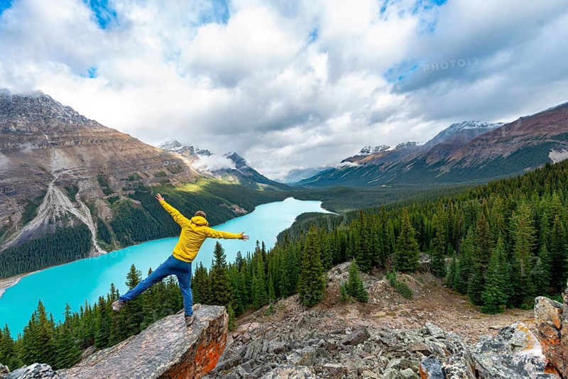 Hiker stretches his arms in the air