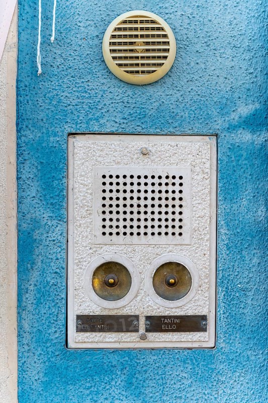 Bell sign on a blue house wall
