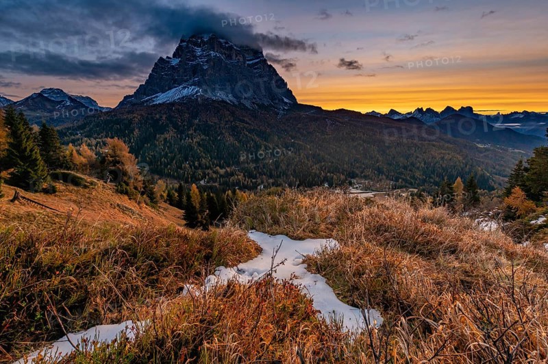 Peak of Monte Pelmo at sunrise with autumn landscape