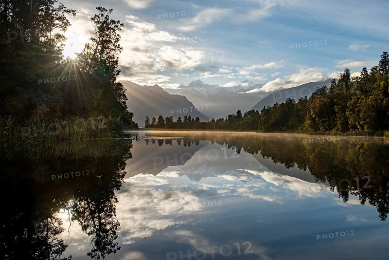 View of Mount Cook in morning light with sun star