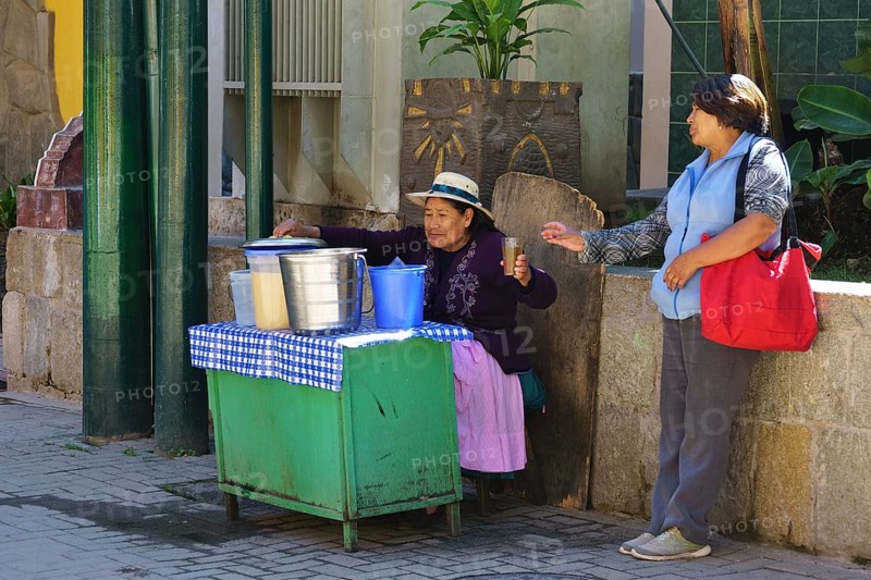 Old woman selling juices at the train station