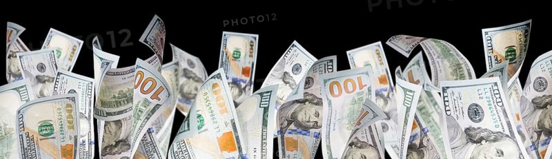 Several one hundred dollar bills falling at base of black page