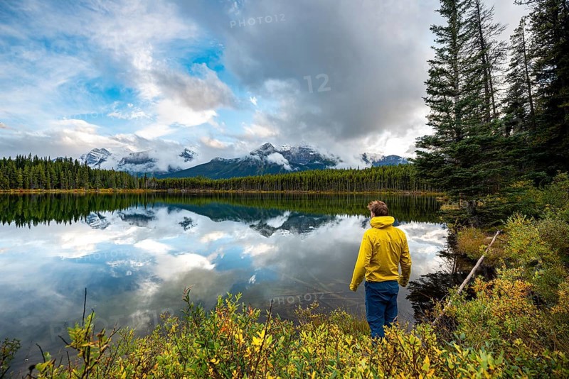 Hiker at the lakeside looking at mountains