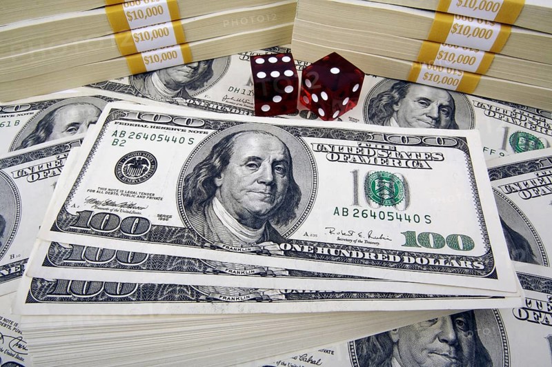 One hundred dollar bills with two red dice