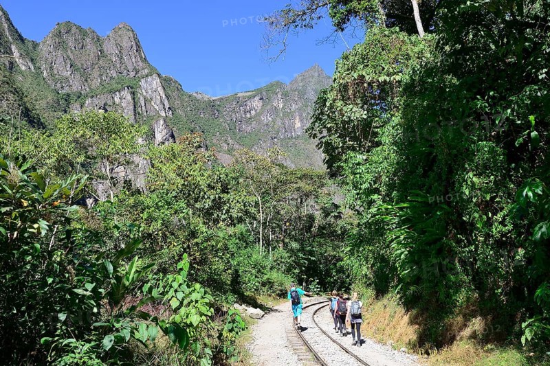 Hikers on the railway tracks in the Urubamba Valley towards Cusco
