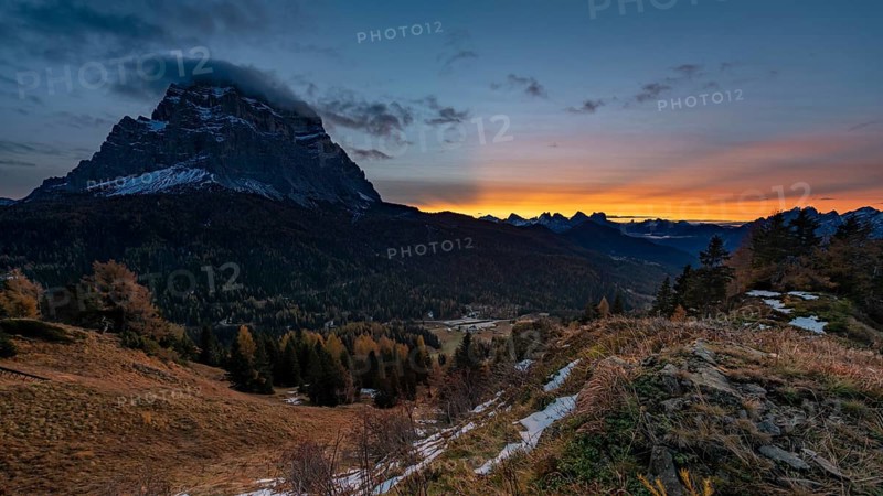 Peak of Monte Pelmo at sunrise with autumn landscape
