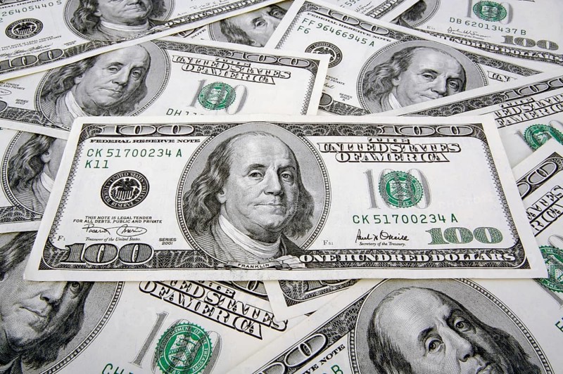 One hundred dollar bills laying flat