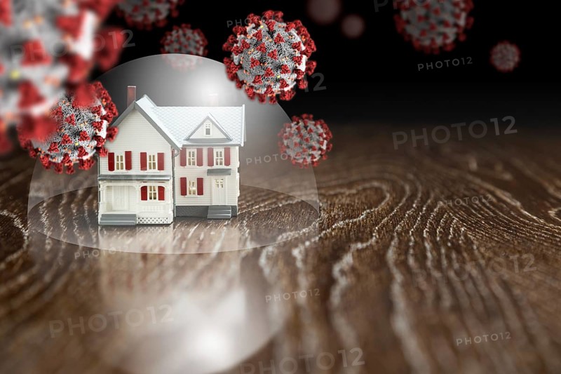 House under protective dome surrounded by floating coronavirus molecules