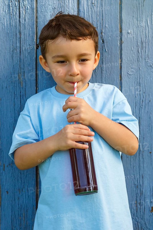 Child little boy drinking cola lemonade drinking bottle